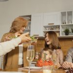 A multigenerational family enjoying a festive dinner indoors, sharing joy and togetherness.